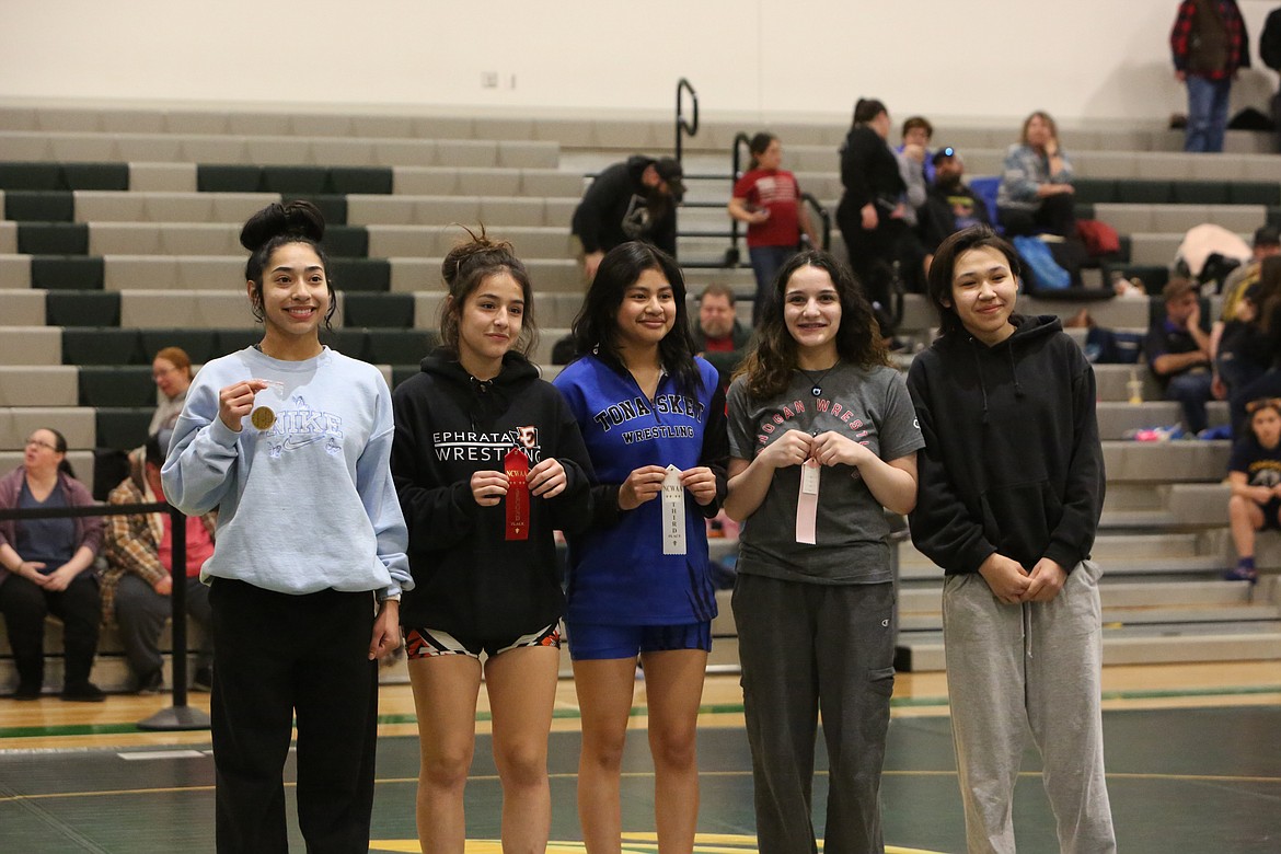 Wrestlers of the 115-pound weight class smile after Saturday’s  2A/1A/2B District 6 Girls Sub-Regional in Quincy. Jackrabbit sophomore Alondra Cordova, left, and Ephrata’s Natalin Abundiz, center left, finished first and second in the 115-pound class, respectively.