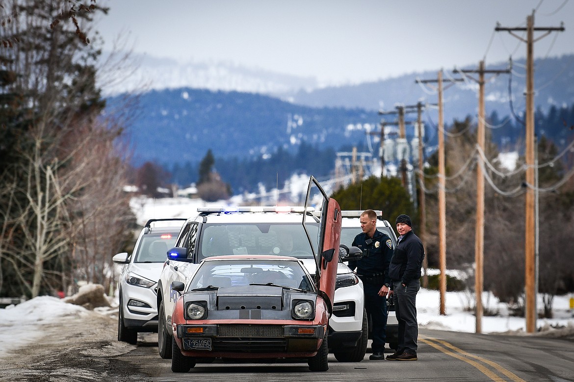 Law enforcement search a vehicle during a traffic stop along Appleway Drive near the scene of a shooting at a hotel on U.S. Highway 2 West in Kalispell on Tuesday, Feb. 7. (Casey Kreider/Daily Inter Lake)