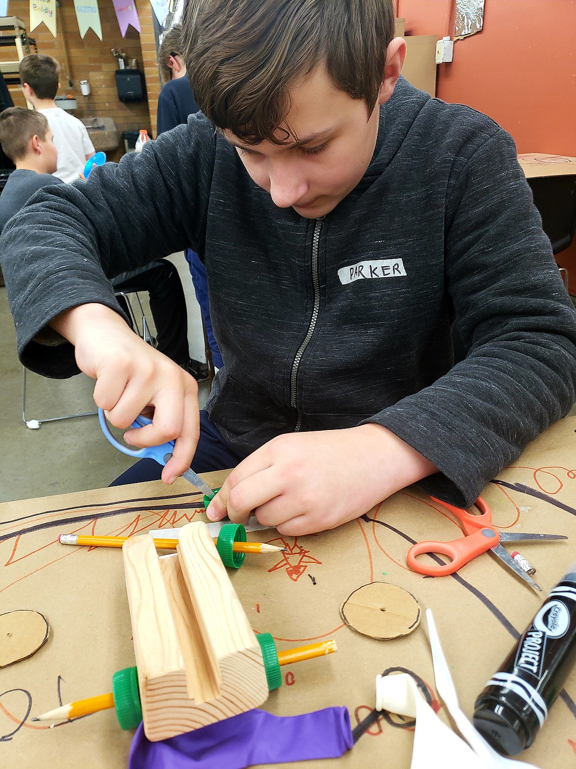 Parker Bright builds a car to compete with brother Preston's in a race to the finish line in Tinker Time on Monday at the Gizmo Coeur d'Alene makerspace at North Idaho College.