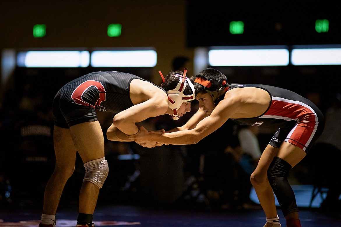 Othello junior Isaac Campos, left, battles against fellow Huskie, freshman Daniel Gonzalez, in the 113-pound finals at the Central Washington Athletic Conference District Tournament on Saturday. Campos and Gonzalez were one of four Othello duos to meet in the finals.