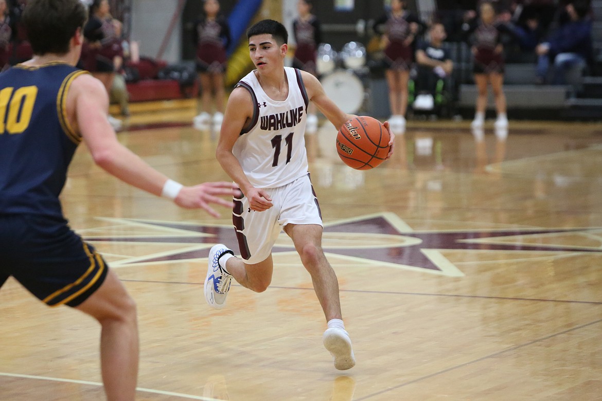 During the fourth quarter of Wahluke’s 61-39 loss to Naches Valley, senior Cristian Madrigal brings the ball up the floor.