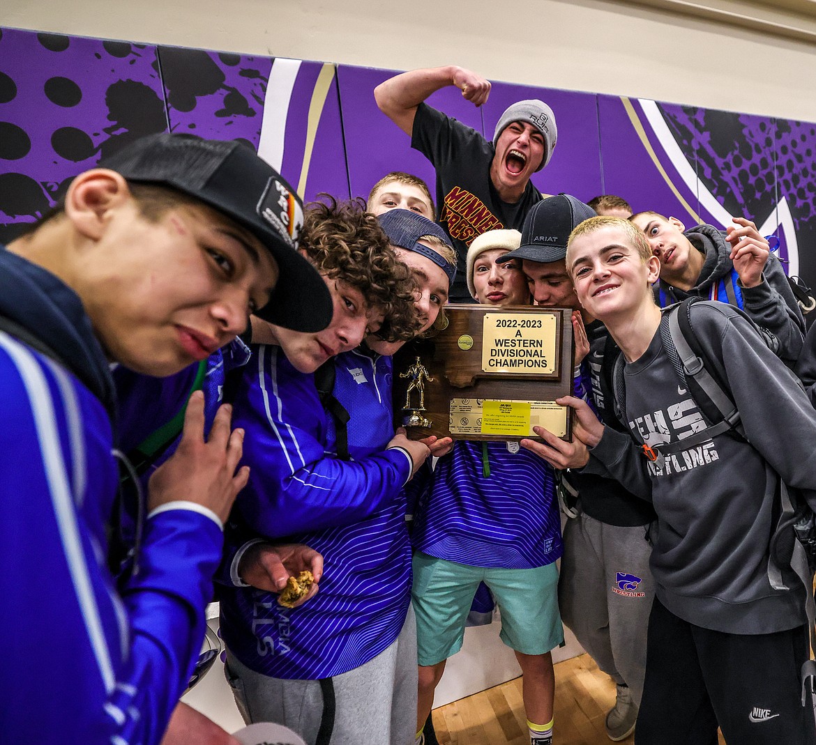 Members of the boys wrestling team hold the divisionals first place trophy in Polson on Saturday. (JP Edge photo)