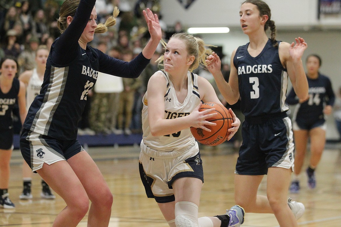 MARK NELKE/Press
Timberlake sophomore Marissa Needs (13) drives to the basket as Markynn Pluid, left, and Brooke Petesch of Bonners Ferry defend during Game 2 of a best-of-3 series for the 3A District 1 girls basketball title Wednesday in Spirit Lake.