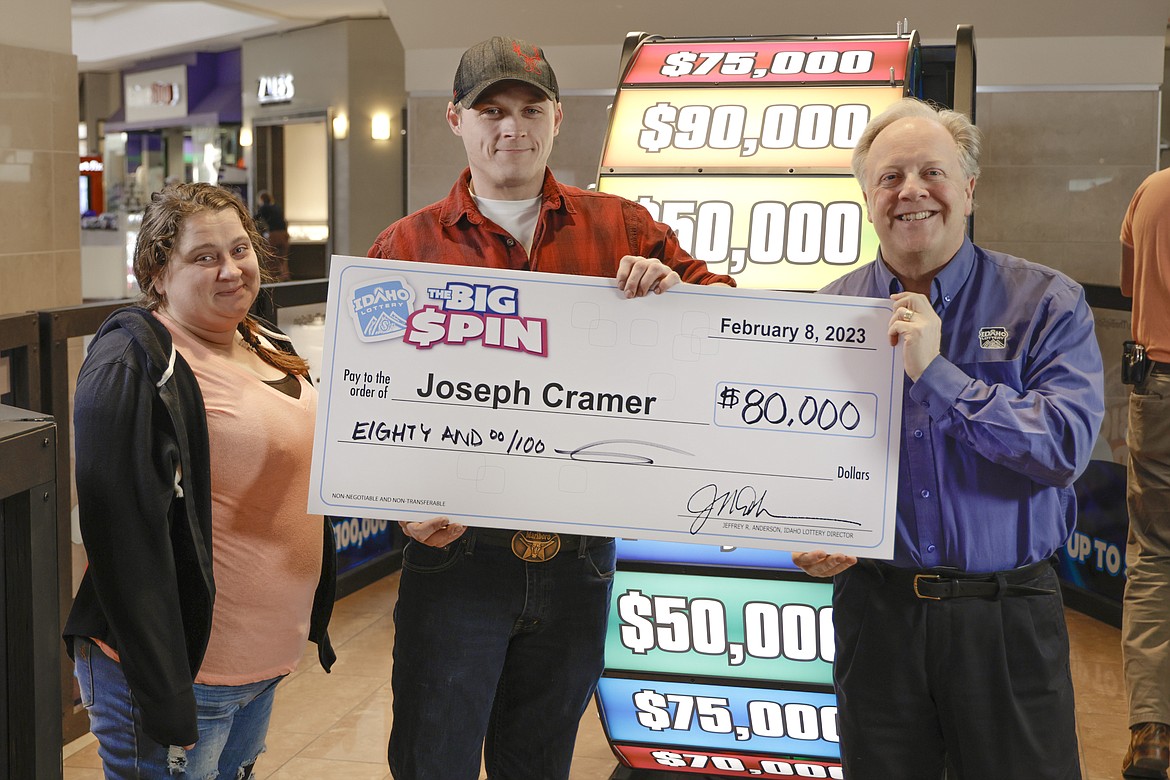 Ashley and Joseph Cramer get their picture taken with Idaho Lottery spokesman David Workman after the Oldtown man won $80,000 on the Big Spin.