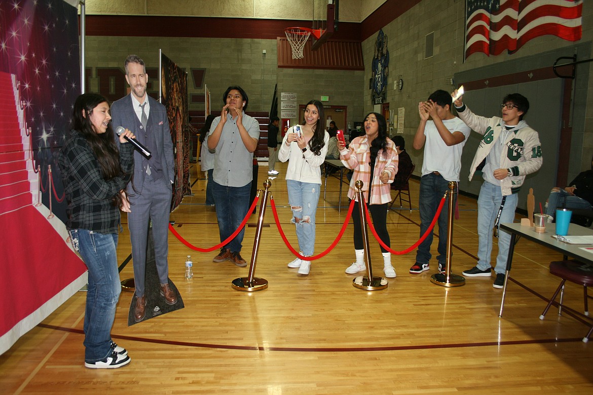 Valerie Oliveras, left, must interview “Ryan Reynolds” in front of a crowd of adoring – and noisy – fans during the Feb. 3 Amazing Shake at Wahluke Junior High School.