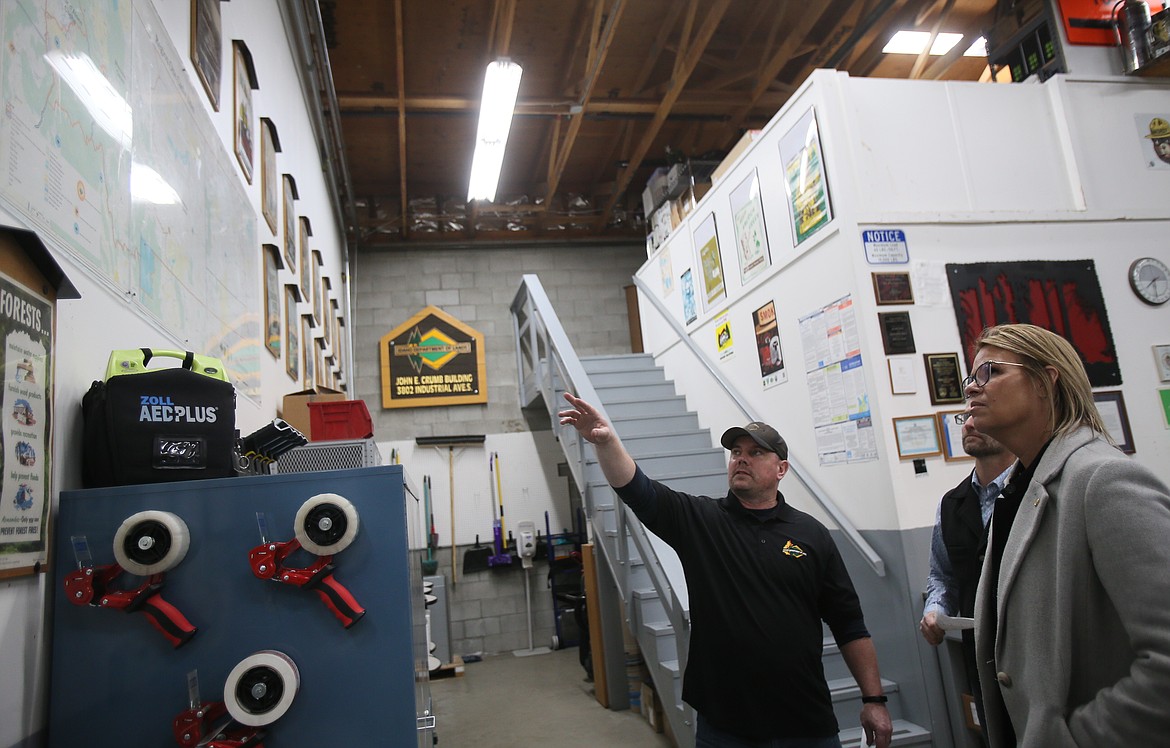 Idaho Superintendent of Public Instruction Debbie Critchfield on Thursday inspects maps pointed out by Idaho Department of Lands fire cache manager Bjorn Jordan during a tour of the Coeur d'Alene site. Critchfield visited to highlight Idaho's needs for skilled workers and how career technical education can help fill the gap.