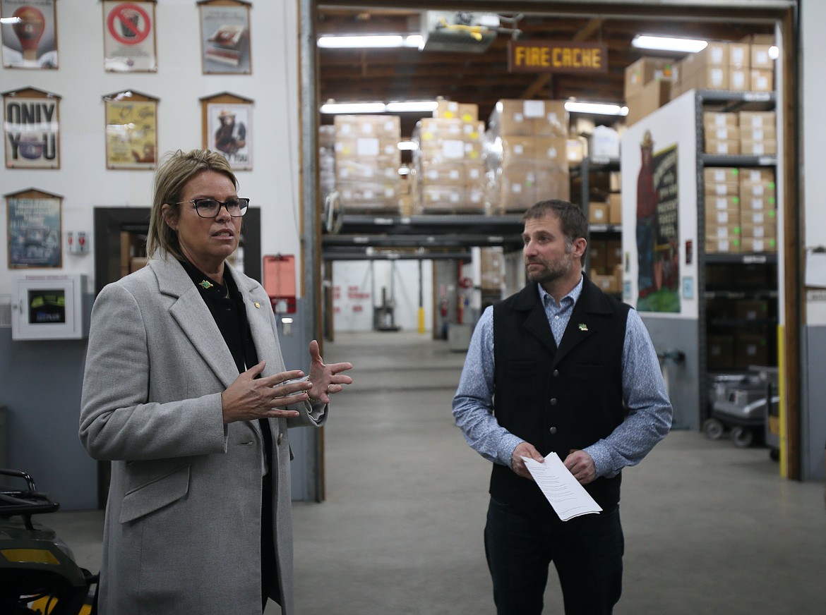 Idaho Superintendent of Public Instruction Debbie Critchfield asks questions Thursday during a tour of the Coeur d'Alene Interagency Fire Cache. Also pictured: Idaho Department of Lands Director Dustin Miller.