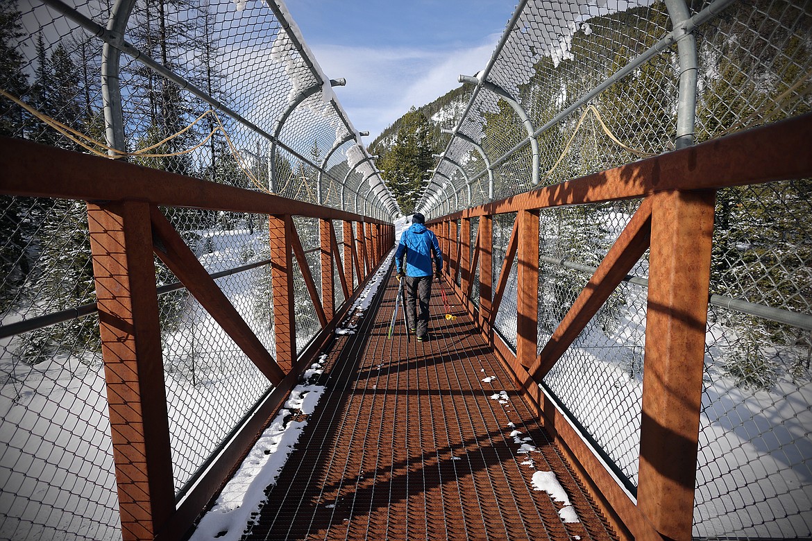 A cross country skier crosses above the railroad tracks to access the trails at the Izaak Walton Inn Thursday, Feb.9, 2023. (Jeremy Weber/Daily Inter Lake)