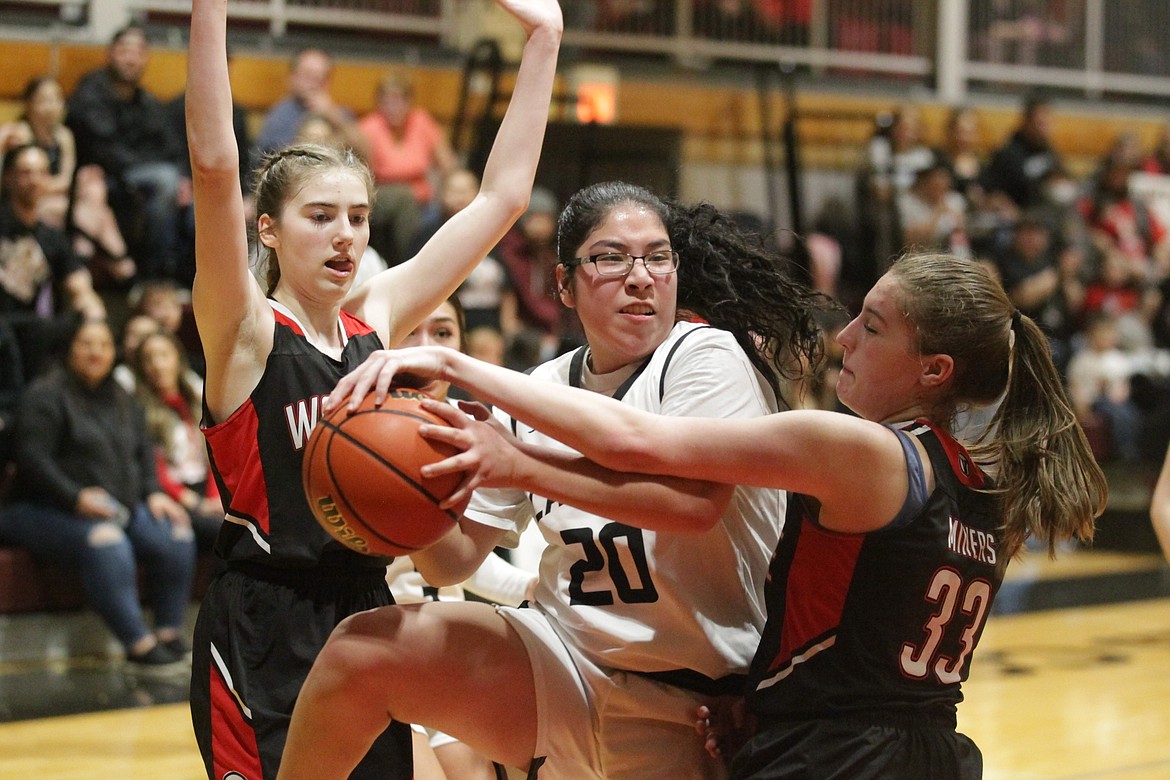 JASON ELLIOTT/Press
Lakeside senior Kiona Allen goes up for a shot while Wallace's Brittany Phillips (21) and Tia Hendrick (33) defend during the 1A Division I District 1 championship game at North Idaho College on Thursday.