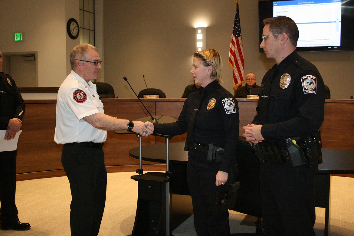 Grant County Fire District 3 Chief Tony Liebelt, left, presents a lifesaving award to Quincy Police Department Sergeant Jazzlynn Silva, center, and QPD Officer Stephen Harder, right, at the Quincy City Council meeting Tuesday. The two officers rescued a woman from a burning house Jan. 10.