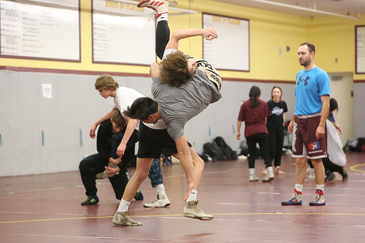 Moses Lake junior Dayton Regan, background, works on takedowns during a Moses Lake practice on Tuesday.