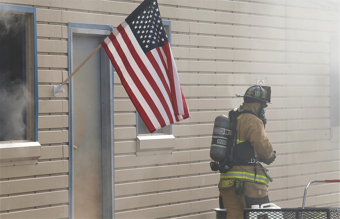 A Coeur d'Alene firefighter leaves a building used for training Thursday.