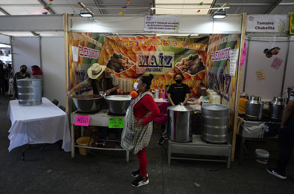 FILE - Vendors wait for clients before the opening of the tamales fair in the Ixtapalapa neighborhood of Mexico City, Jan. 27, 2023. Mexico's annual inflation in January was 7.91% and on Feb. 9, 2023 the Bank of Mexico raised interest rates to 11%. (AP Photo/Fernando Llano, File)