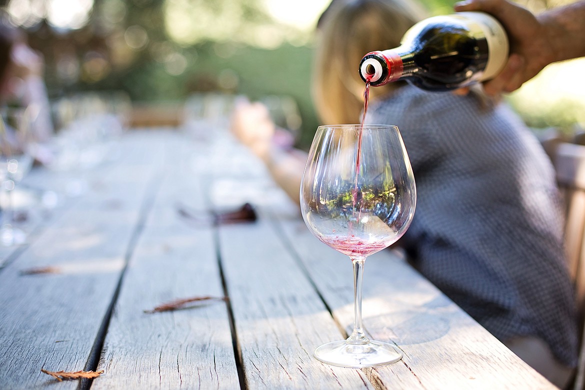 Pouring a glass of wine on a summer day.