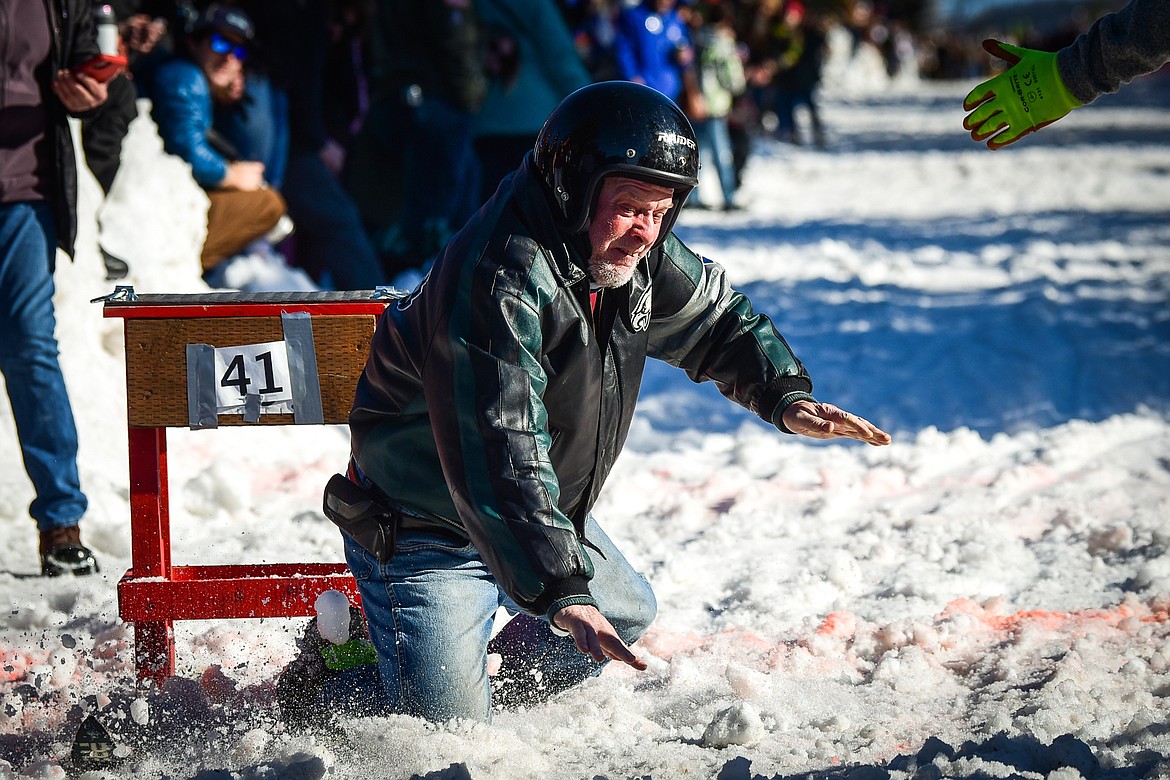 A participant takes a fall during the Barstool Ski Races at Cabin Fever Days in Martin City on Saturday, Feb. 11. (Casey Kreider/Daily Inter Lake)