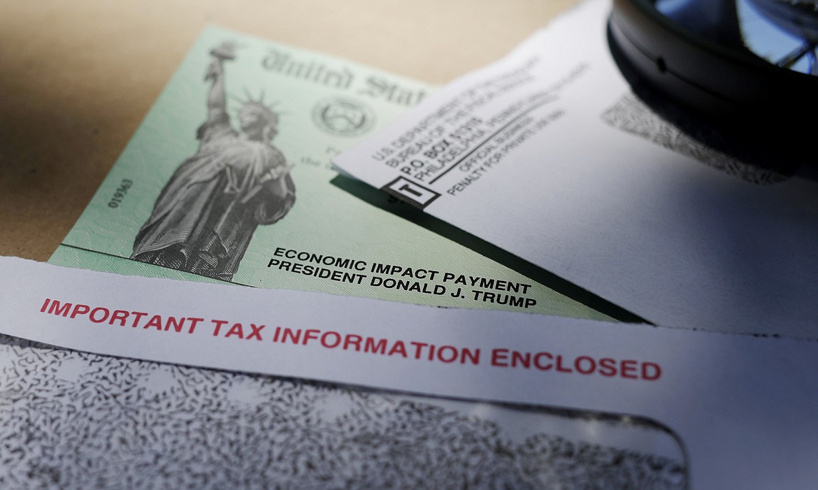 President Donald Trump's name is seen on a stimulus check issued by the IRS to help combat the adverse economic effects of the COVID-19 outbreak, on April 23, 2020, in San Antonio. The IRS announced Friday. Feb. 10, 2023, that most relief checks issued by states last year aren’t subject to federal taxes, providing 11th hour guidance as tax returns start to pour in. (AP Photo/Eric Gay, File)