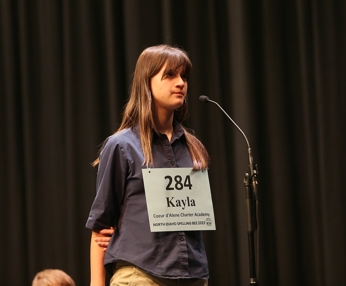 Kayla Tenney Villalobos, a Coeur d'Alene Charter Academy eighth grader, is the champion of the 2023 North Idaho Spelling Bee. She is seen here spelling a word at the microphone Saturday morning in the Schuler Performing Arts Center on the North Idaho College campus.