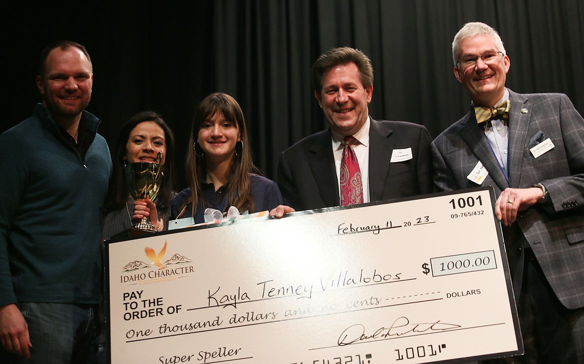 North Idaho Spelling Bee champ Kayla Tenney Villalobos, center, celebrates her win Saturday with parents Brock and Gladys Tenney, left, Idaho Character Foundation founder Dan Pinkerton, to her right, and Coeur d'Alene School District Deputy Superintendent/spelling bee emcee Mike Nelson, far right.