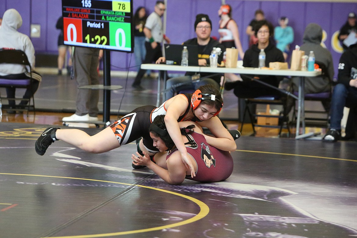 Ephrata freshman Adyene Sanchez, left, works against Wahluke senior Josie Salazar, right, at Saturday’s 2A/1A/2B/1B Region 4 tournament in Spokane on Saturday. Sanchez won the match to advance to the 155-pound finals.