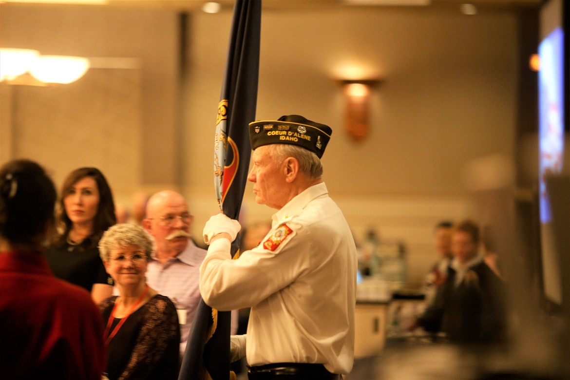 Veteran David Morgensen carries a flag with the Color Guard at the Kootenai County Republican Central Committee's annual Lincoln Day Dinner at The Coeur d'Alene Resort on Saturday.