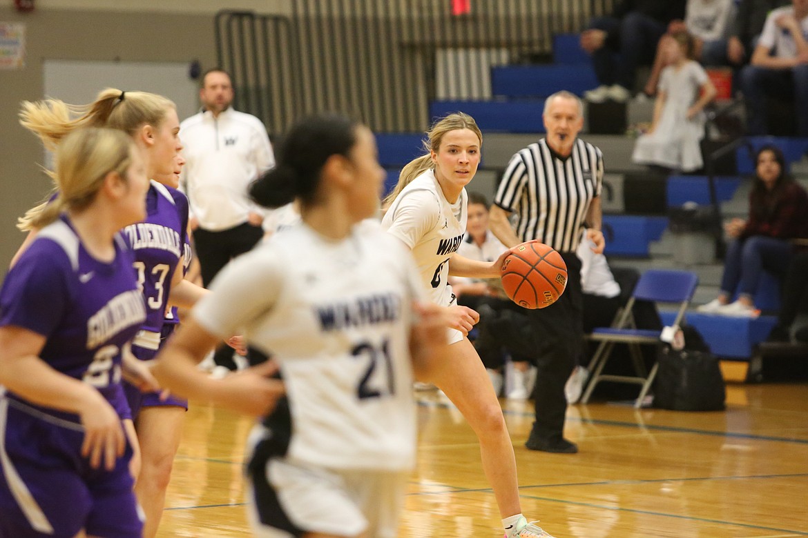 Warden junior Lauryn Madsen, background, dribbles the ball up the floor in transition against Goldendale on Thursday. Madsen scored her 1,000th career point in Thursday’s 76-15 win.