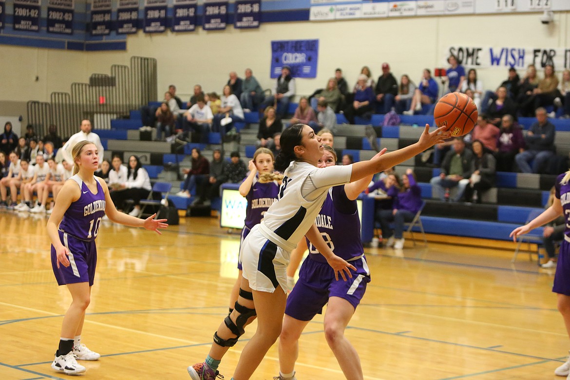 With defenders in her face, Warden senior JLynn Rios stretches to he right to attempt a layup against Goldendale.