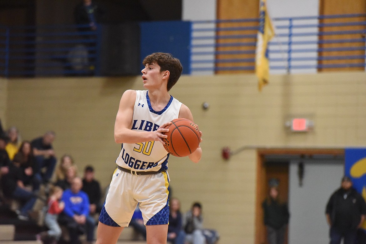 Libby's Trevor Collins looks for the open man against Whitefish Friday night. (Scott Shindledecker/The Western News)