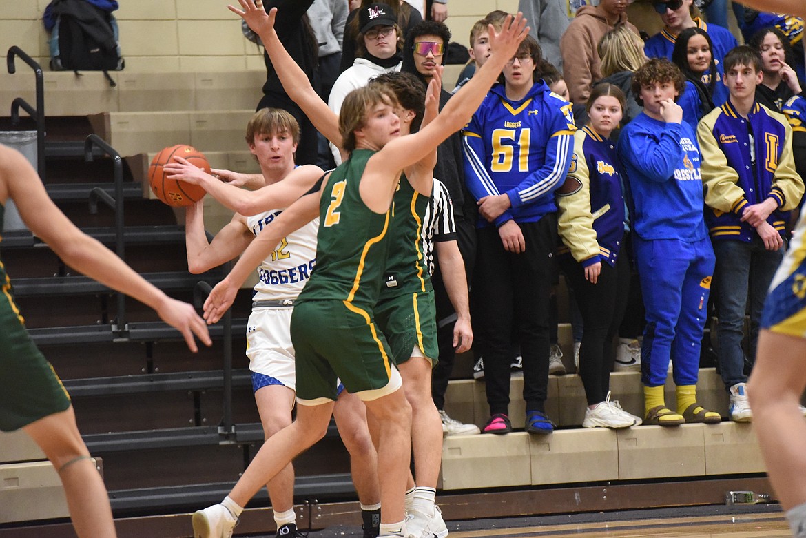 Libby's JR Delmas looks to pass against Whitefish Friday night. (Scott Shindledecker/The Western News)