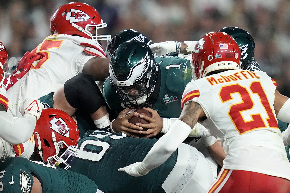 Philadelphia Eagles quarterback Jalen Hurts (1) pushes for the first down against the Kansas City Chiefs during the second half of the NFL Super Bowl 57 football game, Sunday, Feb. 12, 2023, in Glendale, Ariz.