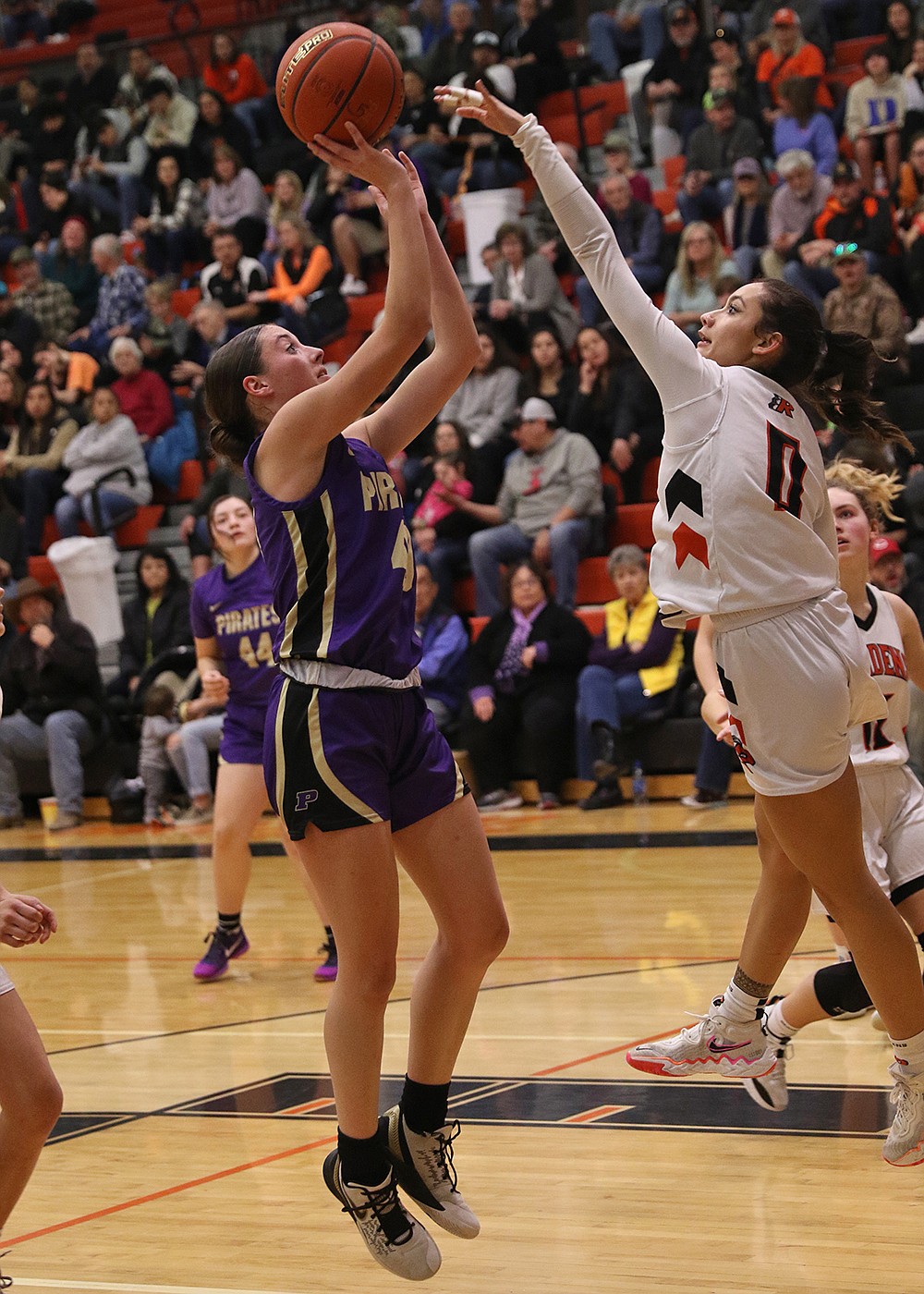 Lady Pirate Nikki Kendall shoots over Maiden Leina Ulutoa Saturday night, in a came marking Polson's second victory over Ronan this season. (Bob Gunderson photo)