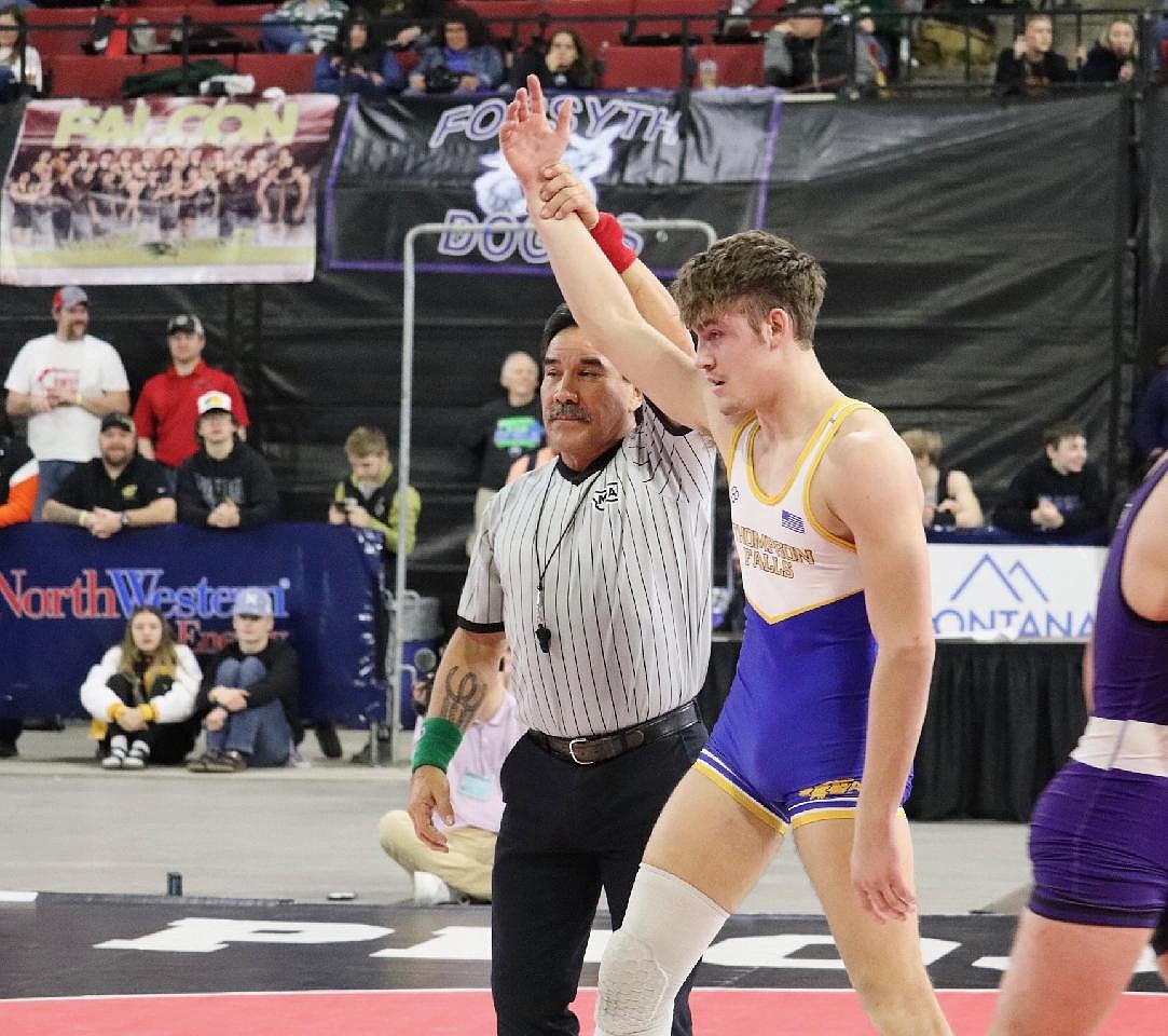 Thompson Falls 170-pounder Max Hannum, a junior, is declared the winner during his championship run at the state tournament in Billings last weekend. (Kami Milender photo)