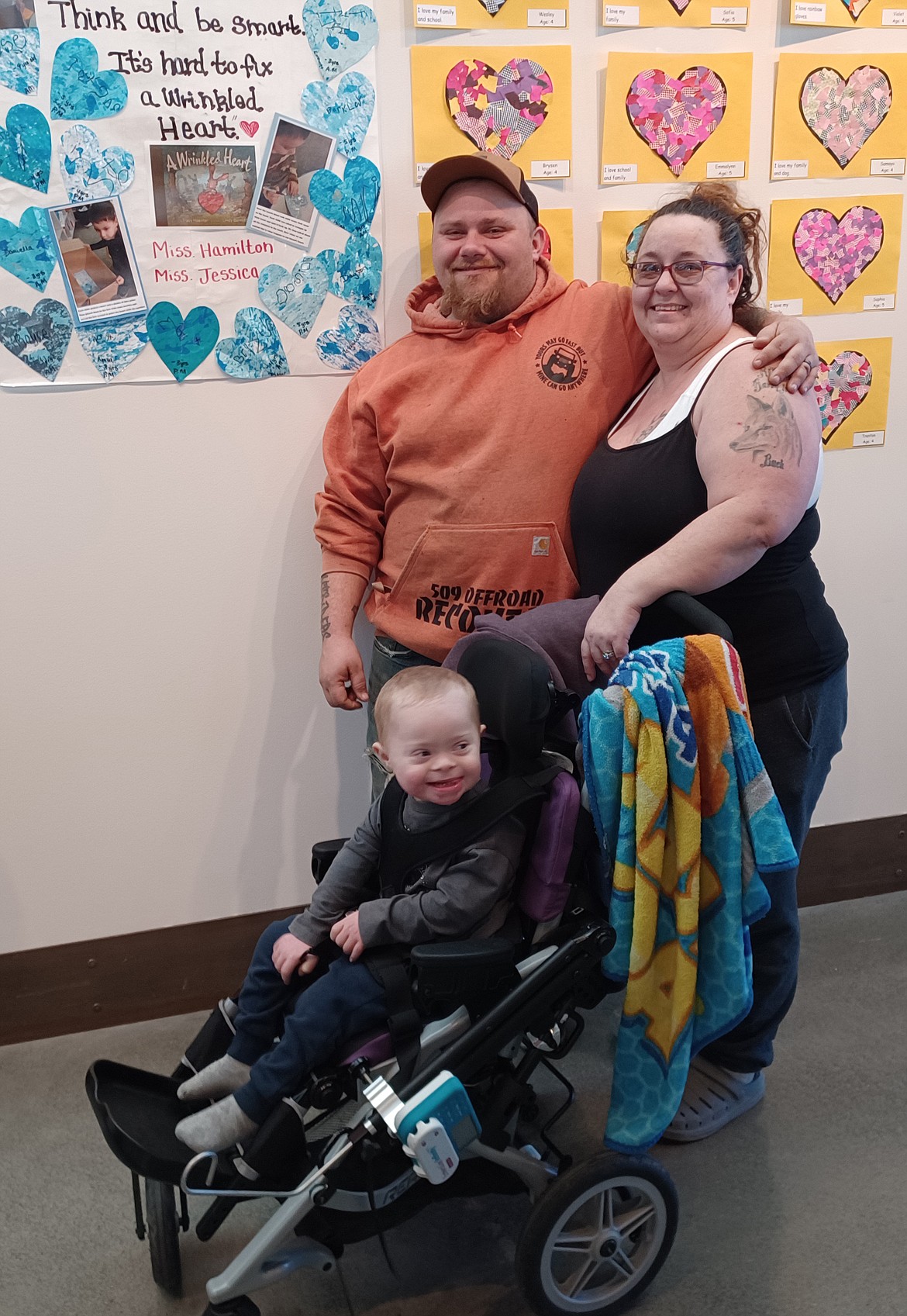 Three-year-old Dayton DeLange and his parents Wayne and Joleen DeLange stand in front of Dayton’s artwork at the Preschool Art Show reception Saturday.