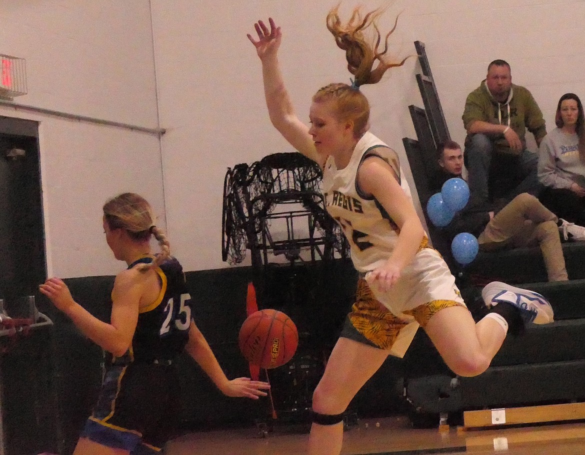 St. Regis forward Macy Hill leaps to chase an errant ball during the Lady Tigers win over Victor Saturday night in St. Regis.  (Chuck Bandel/MI-VP)