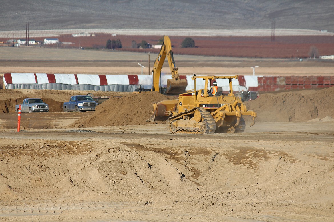 A bulldozer levels ground at the site of the new CyrusOne data center in Quincy.