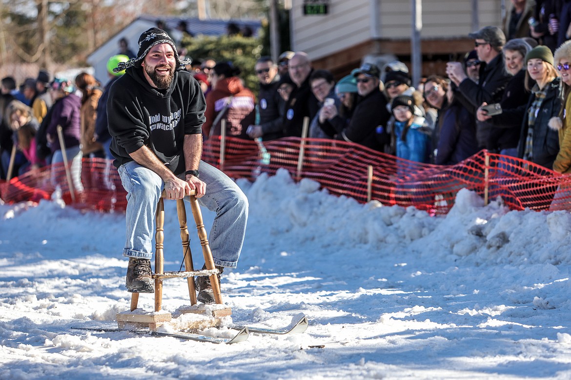 A competitor in the Cabin Fever Days Bar Stool Race cruises down Sugar Hill in Martin City on Saturday. (JP Edge photo)