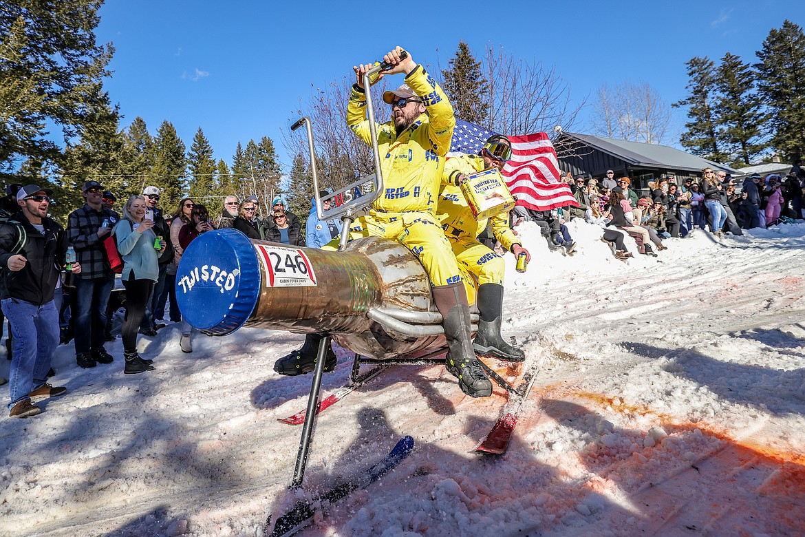 Competitors fly down Sugar Hill on a gigantic bottle of Twisted Tea on Saturday in the Cabin Fever Days Bar Stool Race on Sugar Hill in Martin City. (JP Edge photo)