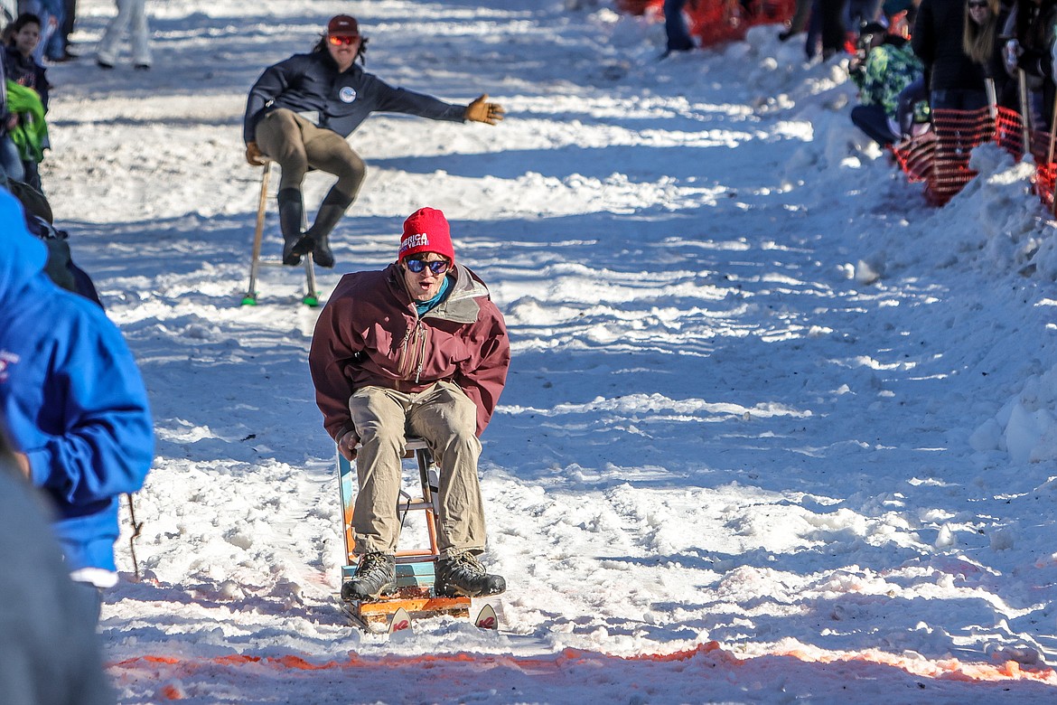 Competitors make it to the finish line of the Bar Stool Race on Sugar Hill during Cabin Fever Days on Saturday. (JP Edge photo)