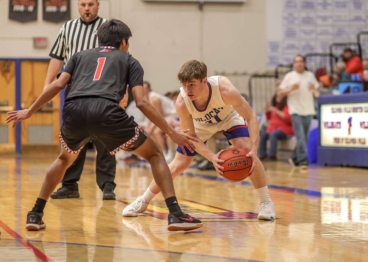 Junior Mark Robison faces off a Ronan opponent at home on Thursday. (JP Edge photo)