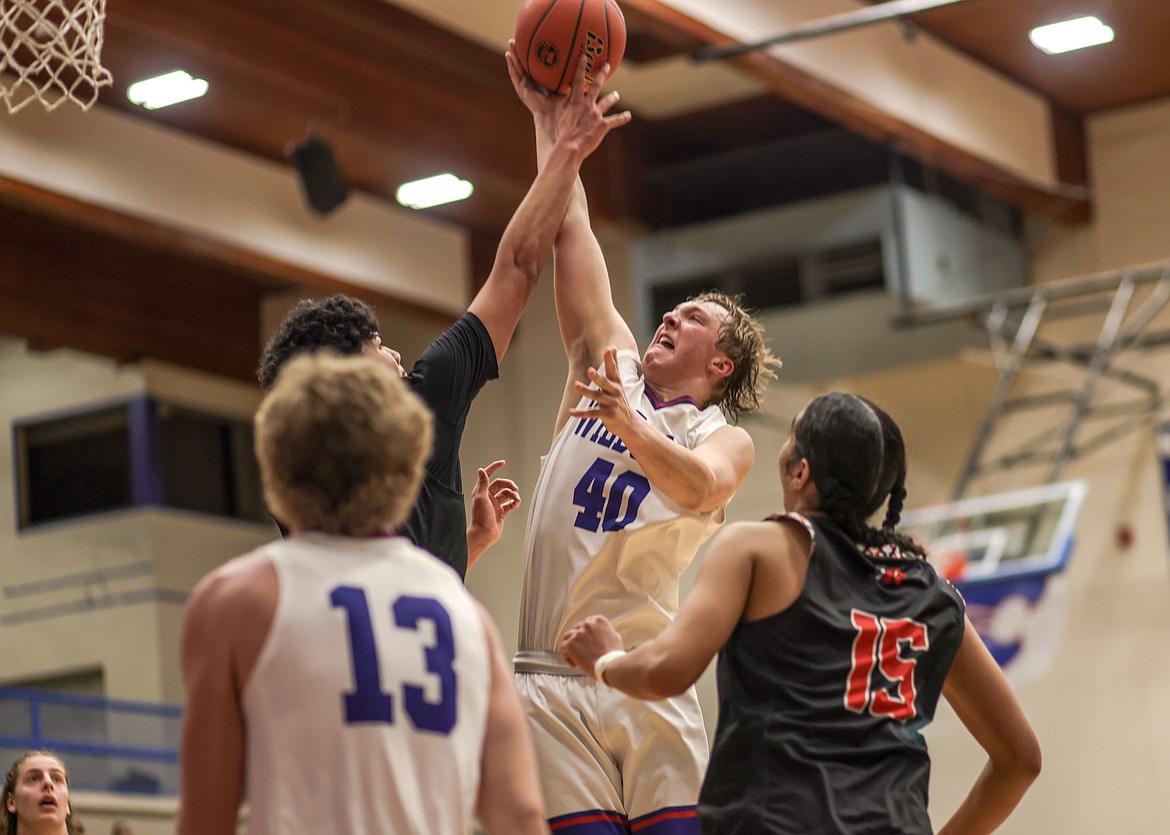 Junior Hunter goodman goes up for a ball against Ronan opponent on Thursday. (JP Edge photo)