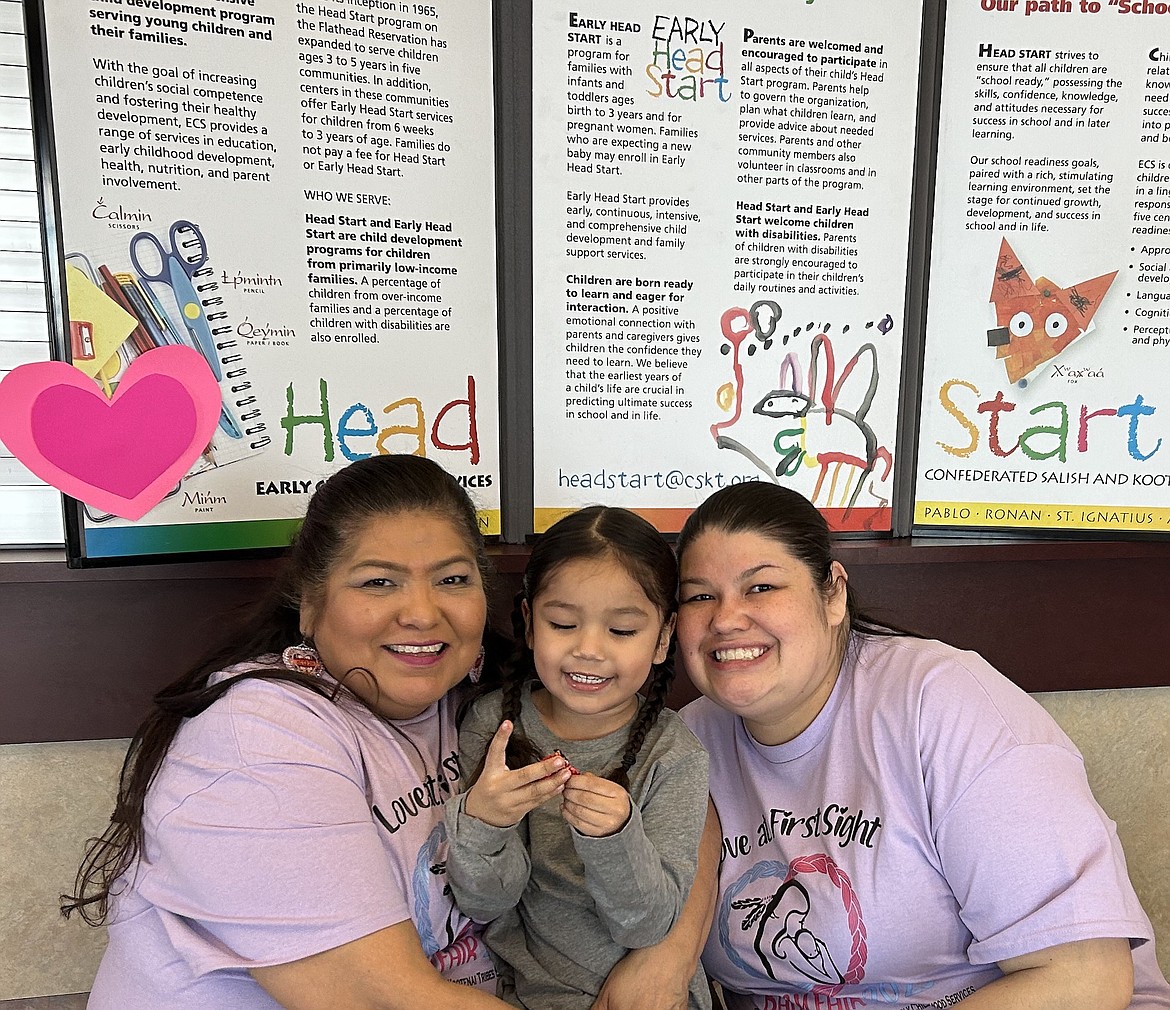 The CSKT Baby Fair, held Saturday at Salish Kootenai College in Pablo, drew new and expecting parents to the college gym. Exhibitors included Rechandra Almaguer of Early Childhood Services with her grandson, Ezekiel, and Head Start teacher Lauren Edwards. (Shirley Azzopardi photo)