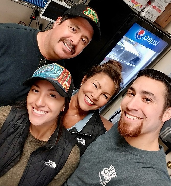 Joel Aispuro Sr., left, poses with his wife Rebeca, daughter Veronica and son Joel, in the family's popular restaurant, Joel's Mexican Restaurant on Church Street in downtown Sandpoint.