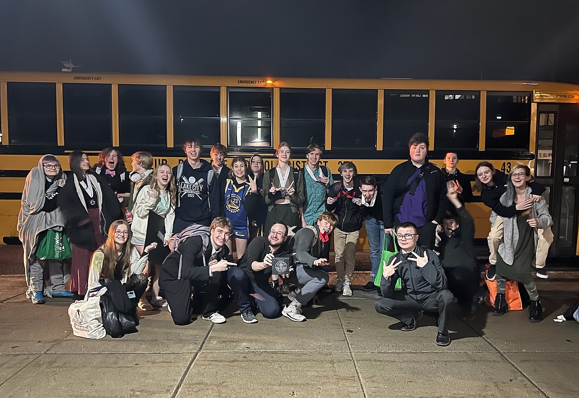 Lake City Speech and Debate team members pose before getting on the bus at 11:30 p.m. Feb. 4 after a three-day Thomas S. Foley Memorial Tournament and almost 34 hours of competition. The students won third place in the Large School Division. Coach Caleb Drechsel holds the students' hard-earned third-place plaque while students flash their “bling.”