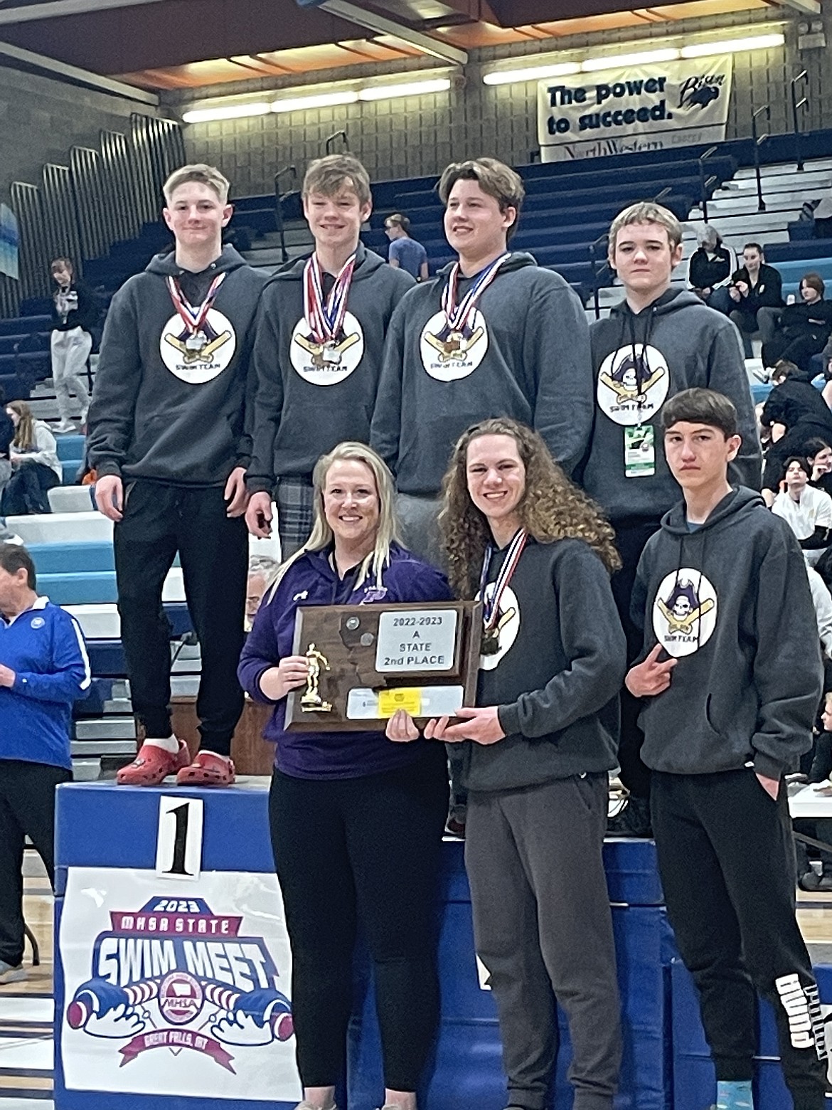 Polson Boys placed second overall at the Montana State Swim Meet. Pictured on the podium are (top row): Teague McElwee, Truman Sawyer, Lachlan Sloan and Josh Reed; and (bottom row) Coach Morgan Zimmer, Gus Hertz and Hayden Clairmont. (Photo by Sharon Hertz)