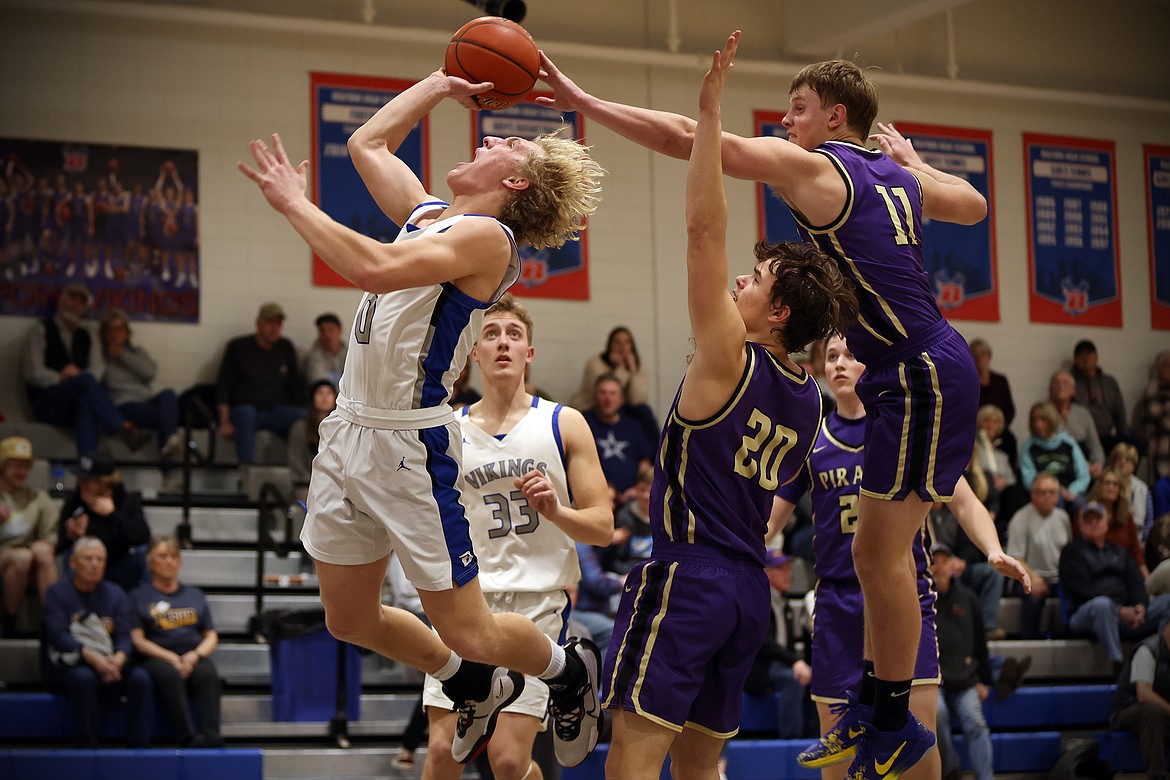 Polson's Dawson DuMont stretches out to block a shot by the Vikings' Wyatt Johnson during action in Bigfork Feb. 7. (Jeremy Weber/Daily Inter Lake)