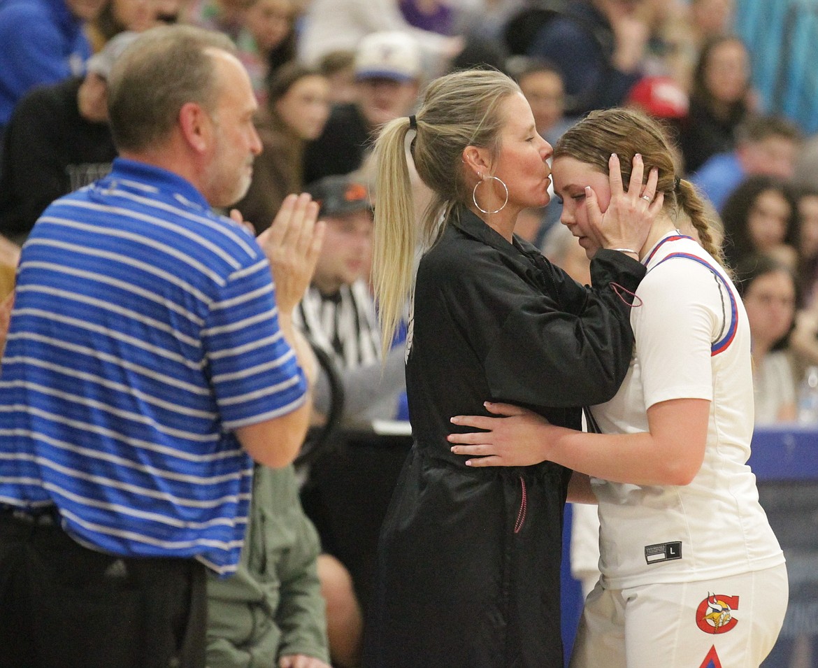 JASON ELLIOTT/Press
Coeur d'Alene girls basketball coach Nicole Symons kisses her daughter, Madi, on the forehead in the final two minutes of the 5A Region 1 championship game at Viking Court.