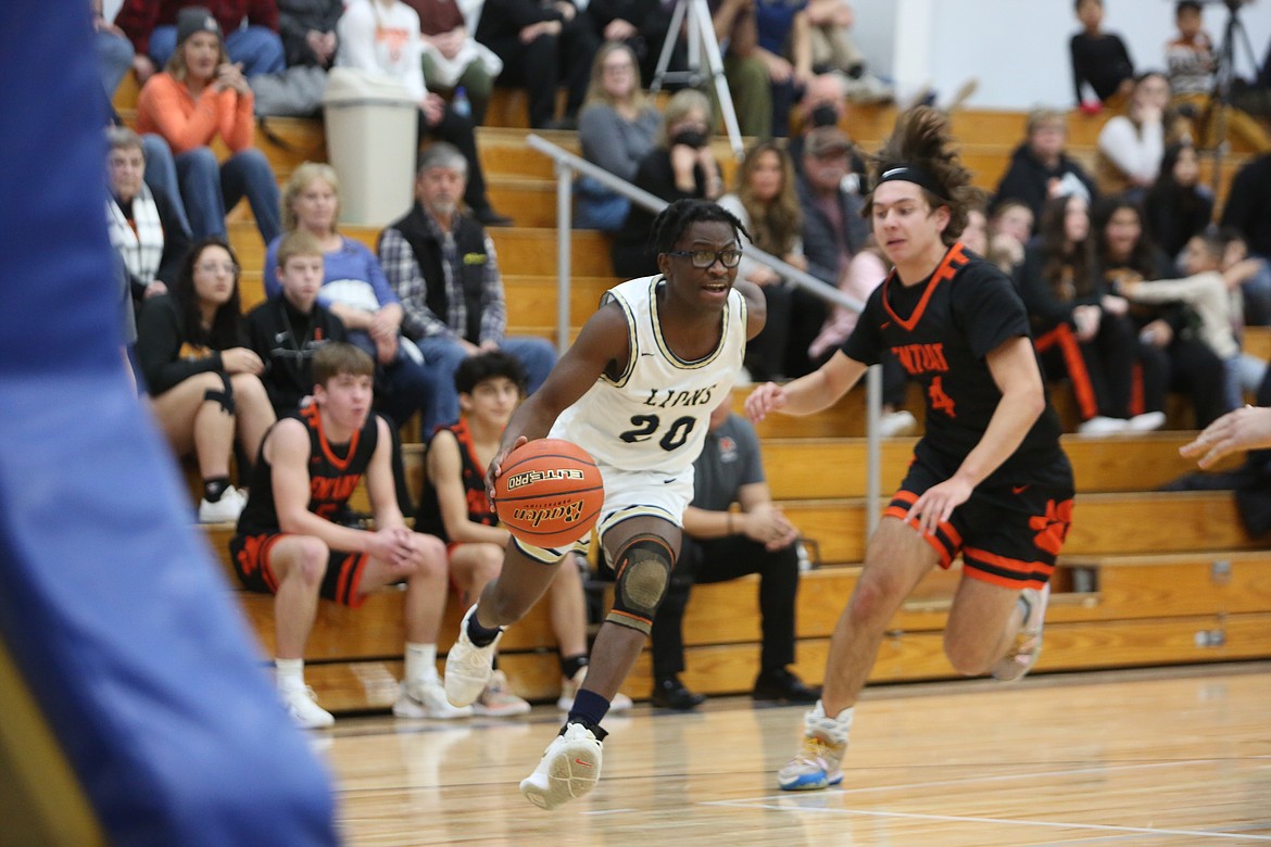 MLCA/CCS senior Jeff Boorman, left, drives into the paint against Entiat. Boorman connected on two three-pointers in the fourth quarter against Soap Lake on Friday, contributing to a 25-point quarter for the Lions.