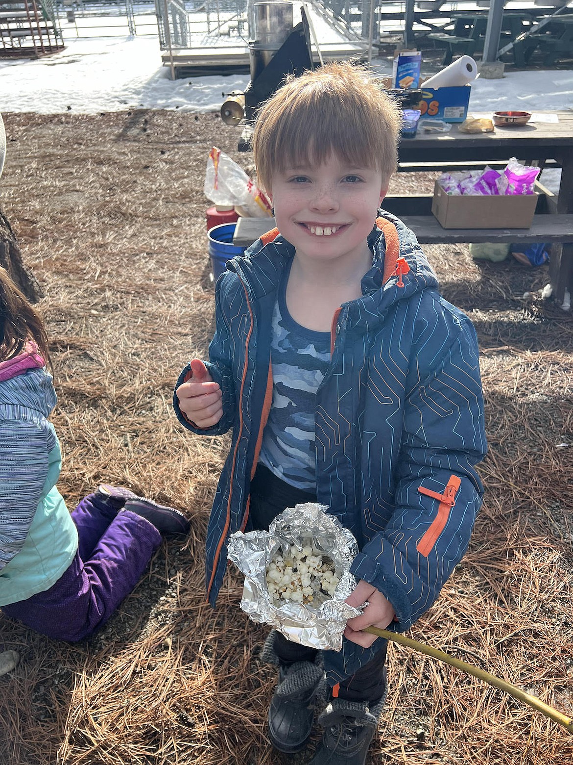 Libby Elementary School student Jaxon Smith shows off the popcorn he made over an open fire at the Winter Tracks event on Friday, Feb. 10. (Photo courtesy Jessica Thoeny)