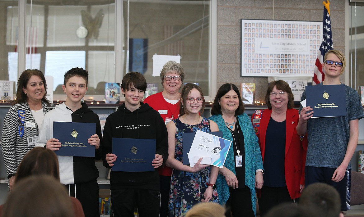 River City Middle School students are honored Wednesday for participating in the Daughters of the American Revolution American History Essay Contest. Essays by Hailey Farr and Derek Theoret will be submitted into the state contest. From left: DAR member Stephanie Keaty, James Albaugh, Mark Dressler, DAR member Patty Stills, Hailey, English teacher Nancy Hicks, DAR Vice Regent Michelle Fansler and Derek.