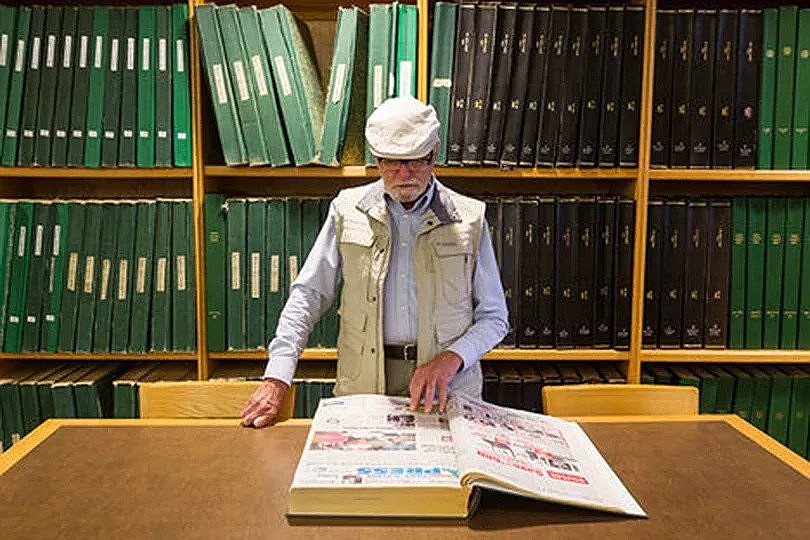 Local historian Robert Singletary perusing old copies of the Coeur d’Alene Press.