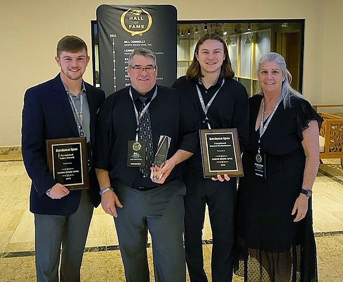 Bill Connolly, second from left, poses with sons Tyler (far left) and Garrett (second from right) and sister Deborah Connolly Eggleston after North Idaho Spas was recognized by Jacuzzi/Sundance Spas at their annual dealer conference held in Punta Cana, Dominican Republic, in January.